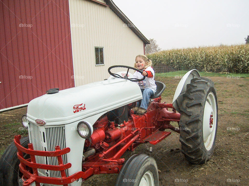 On the Farm- Daughter pretending to drive tractor.