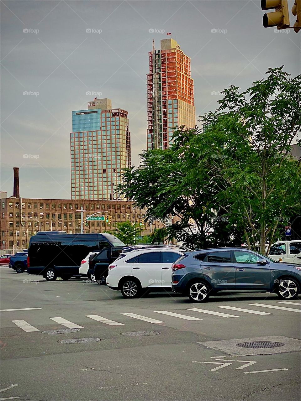 The corner of “Borden Ave” along “Newtown Creek”, an ocean inlet of the “East River” towards the “Pulaski Bridge” that connects LIC, Queens to “Greenpoint”, Bklyn. 2022. Hypnotic Productions