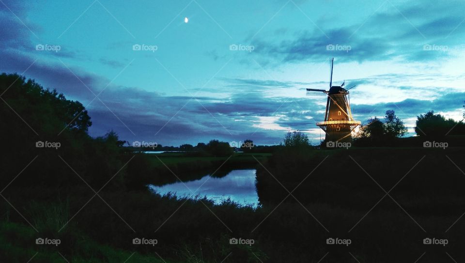 Windmill by Twilight. Windmill in Holland by twilight facing rainy clouds