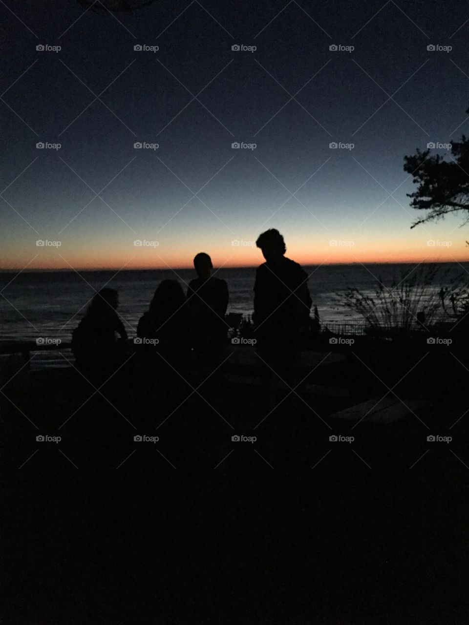 Setting sun. A group of people enjoying the last moments of the day in Big Sur, California 