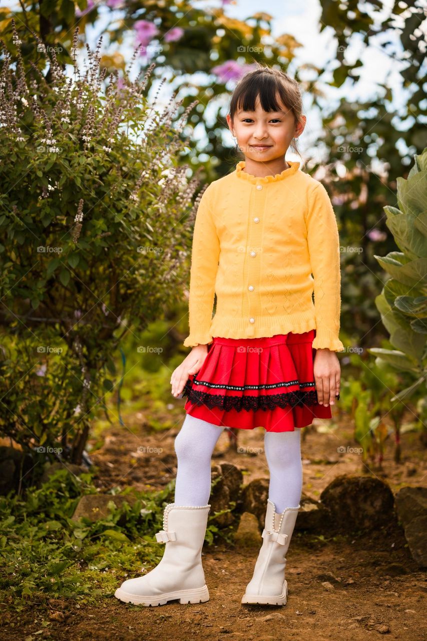 Environmental Portrait of a little girl in vibrant colored dress.