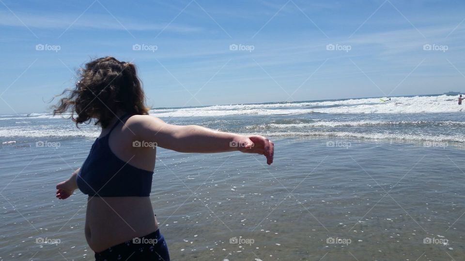 my daughter enjoying the ocean breeze while on vacation in California.