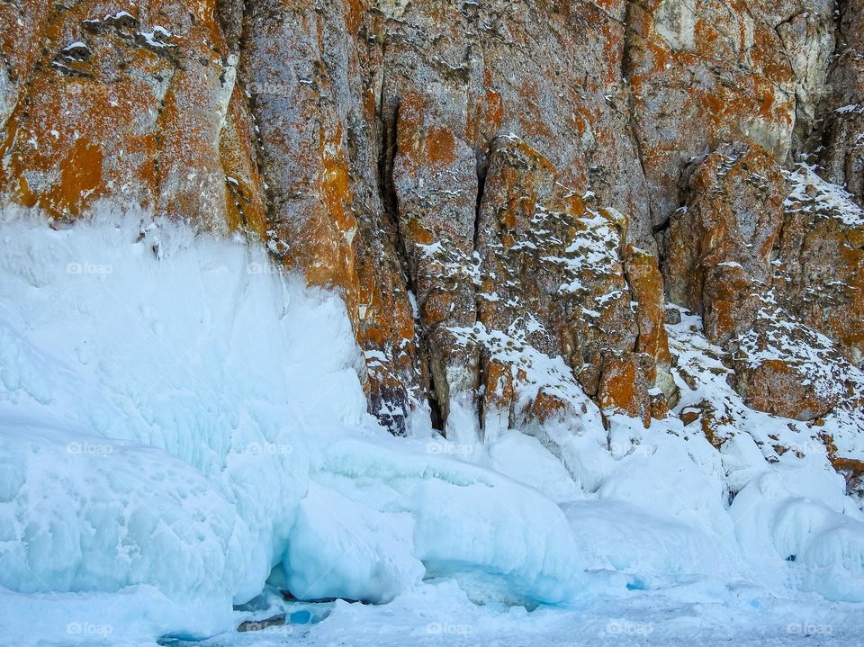 Sokuy on the rocks of cape Sagan-Khushun. Sokuy is a type of ice on lake Baikal. Cape Sagan-Khushun, Olkhon island, Olkhonsky district, Irkutsk region, Siberia, Russia.