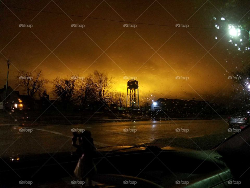 light pollution in fog behind a water tower