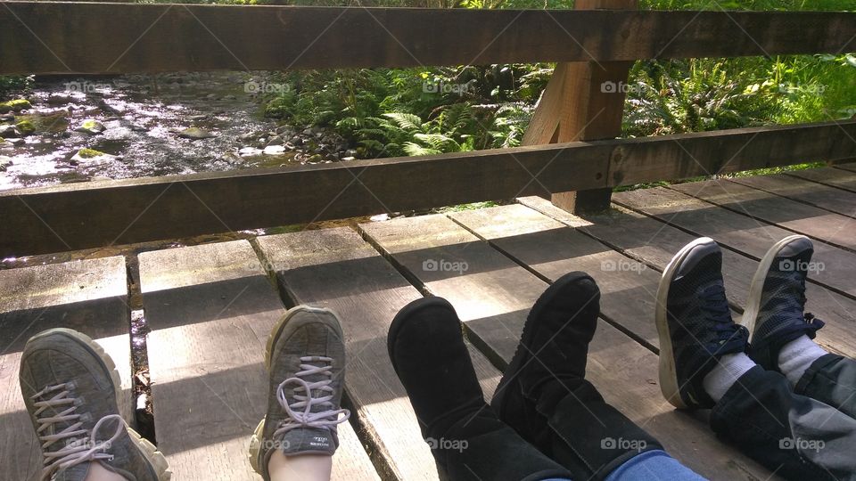 The feet we hike with! 40 years of friendship sitting on a bridge watching the river go by!