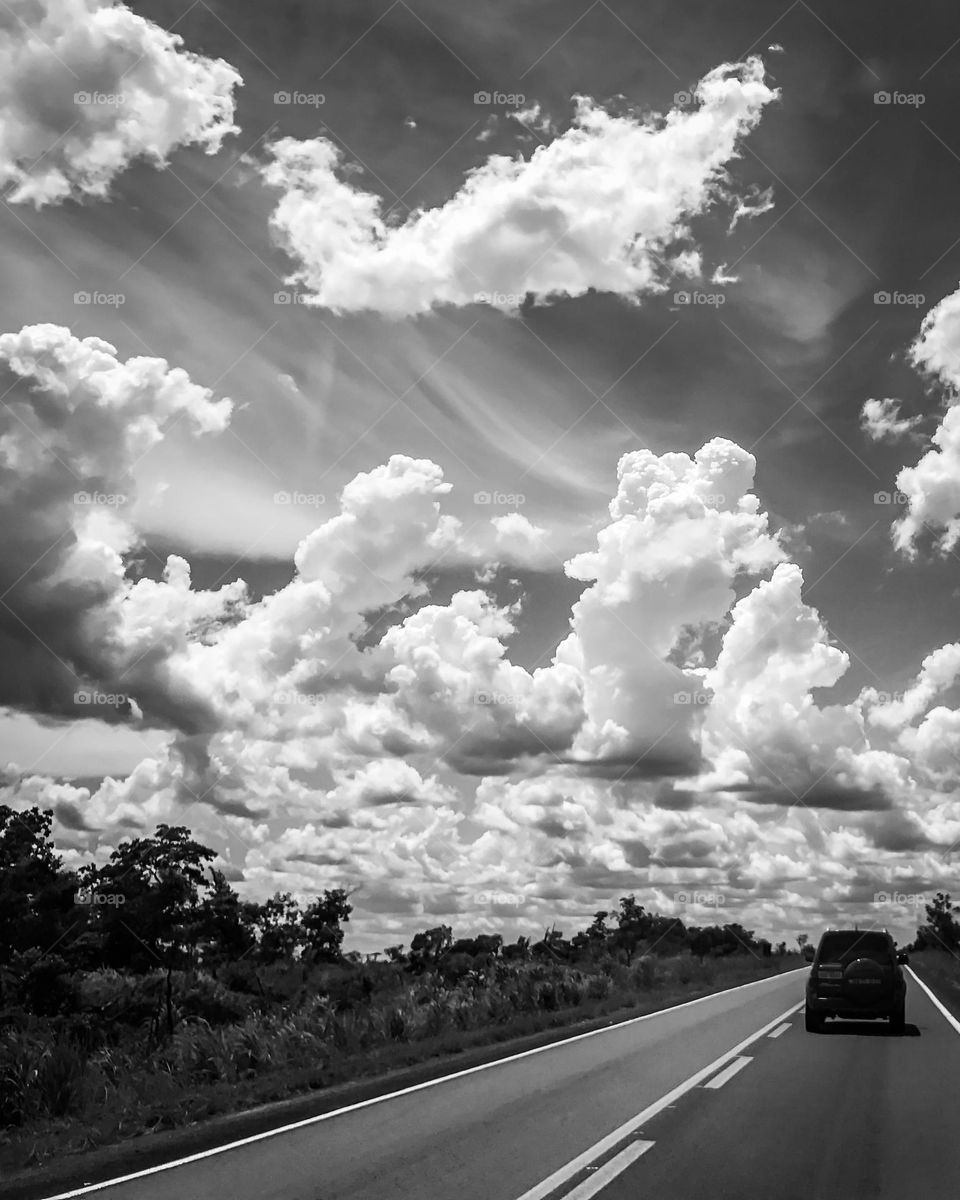 Car in a road and cloudy sky 