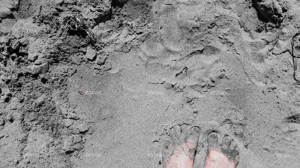 Walking down a sandy beach.