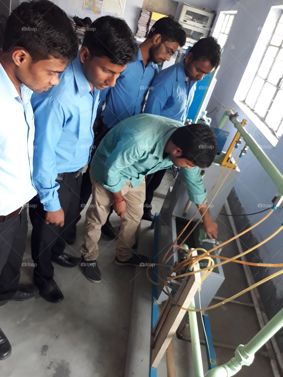 Performing  hydraulic  laboratory  in engg.  College