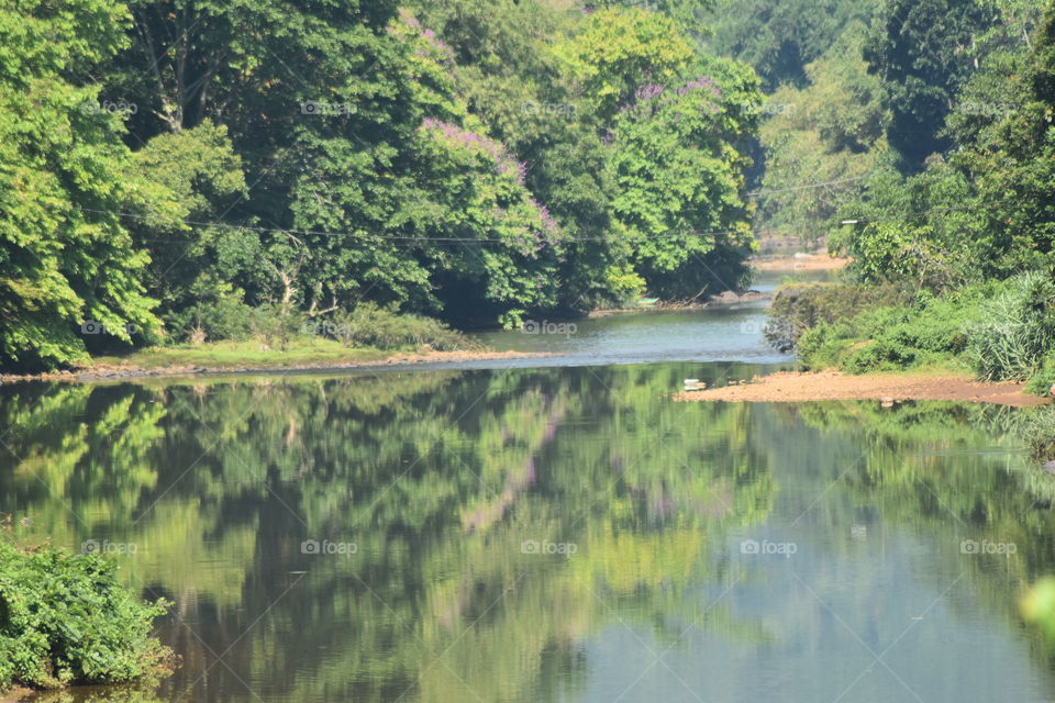 It is a beautiful river calmly flowing through forest and beautiful mountains