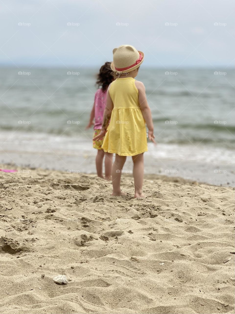 Two little girls on the beach 