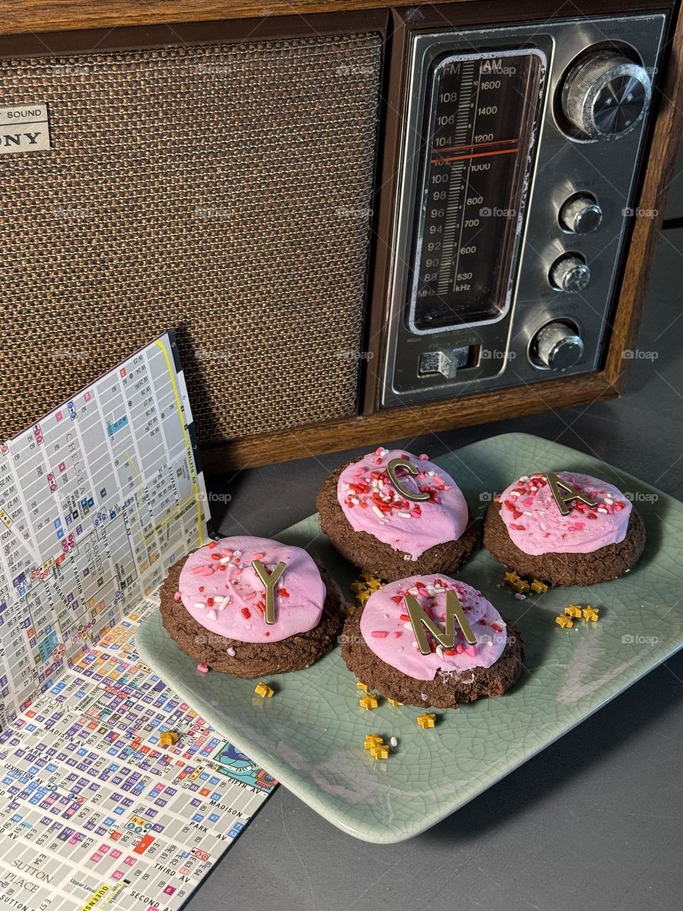 1970’s Sony AM-FM table radio with plate of decorated cookies spelling YMCA, Village People’s song with map of NYC