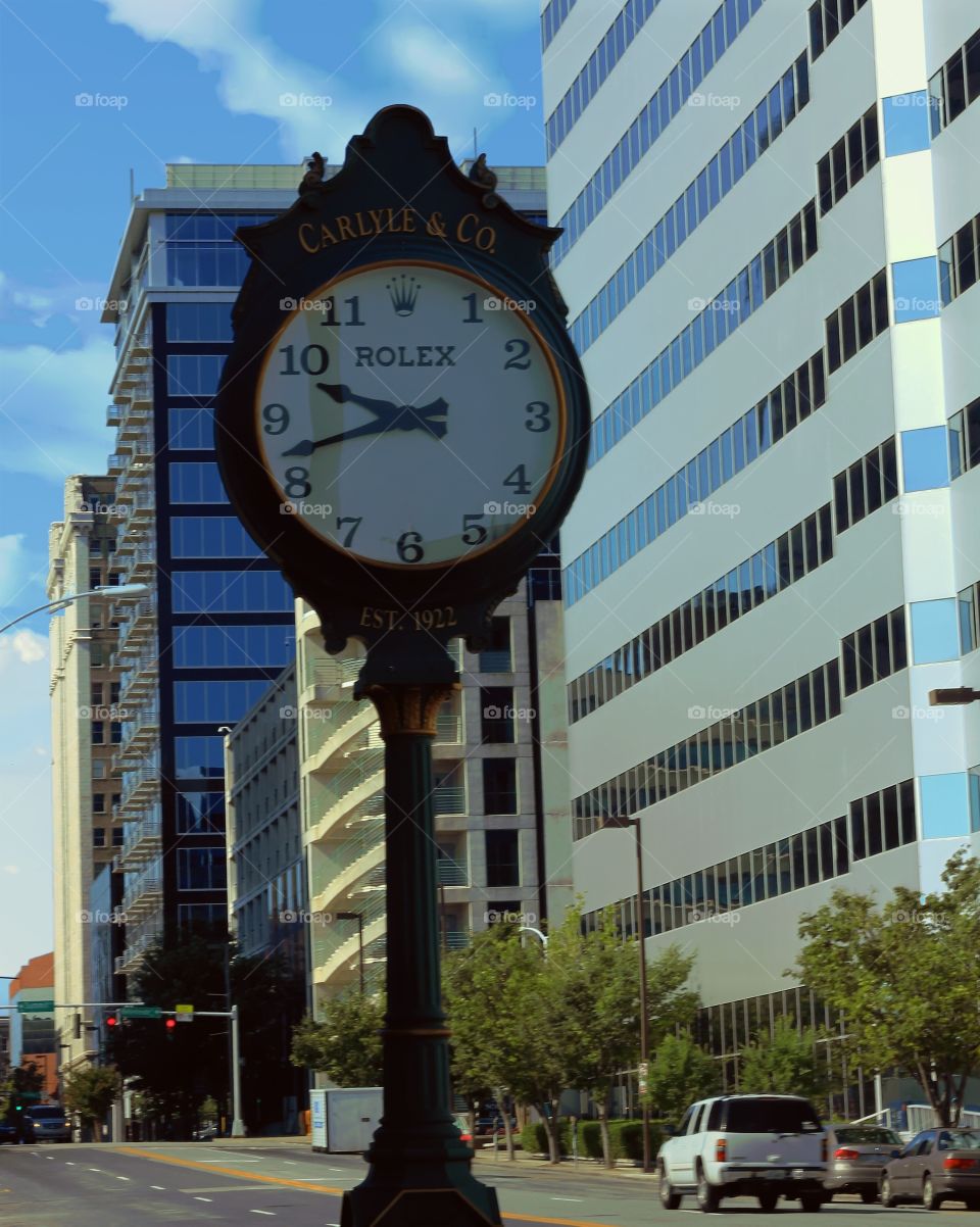 Downtown time looking down mainstreet on sunny day.