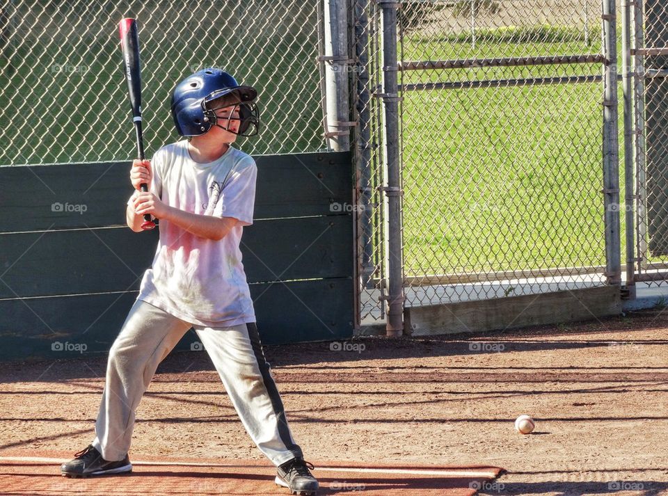 Young Slugger At Bat. Young Boy Playing Baseball
