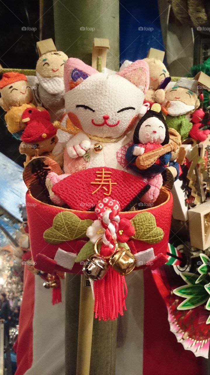 fortune cat figure. This is one of Japanese cultural objects, Kumanote. It is said that this brings good fortune.
