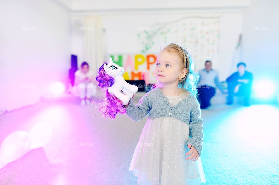 Little girl with unicorn 
