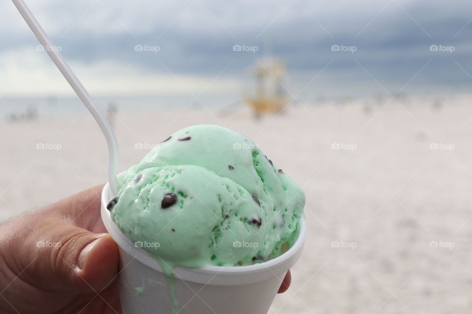 Having mint ice cream with chocolate chip on the beach 