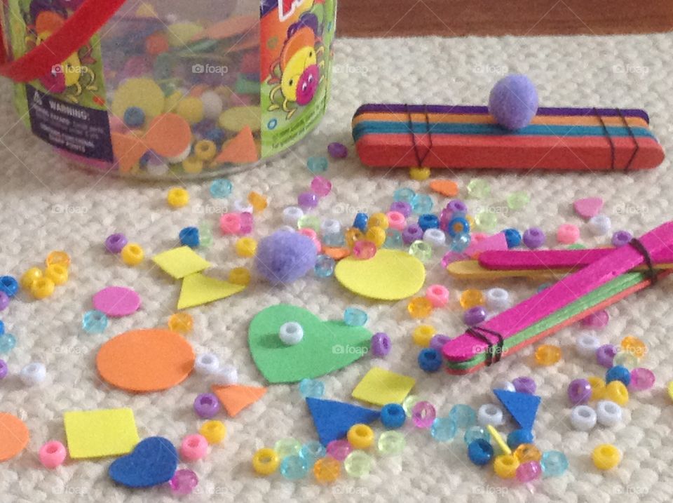 Colorful beads, popcicle sticks and different shape stickers for arts and crafts supplies. 