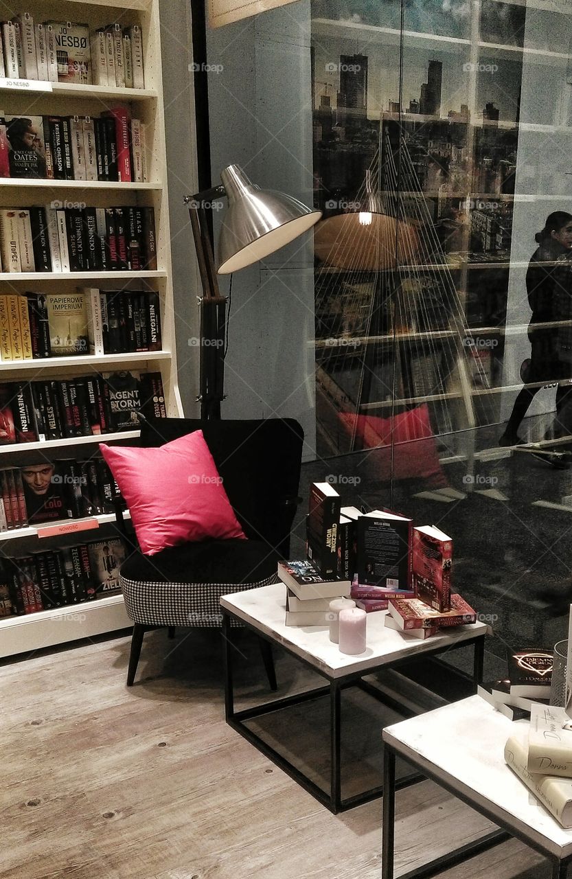 Armchair and lamp in cozy bookstore