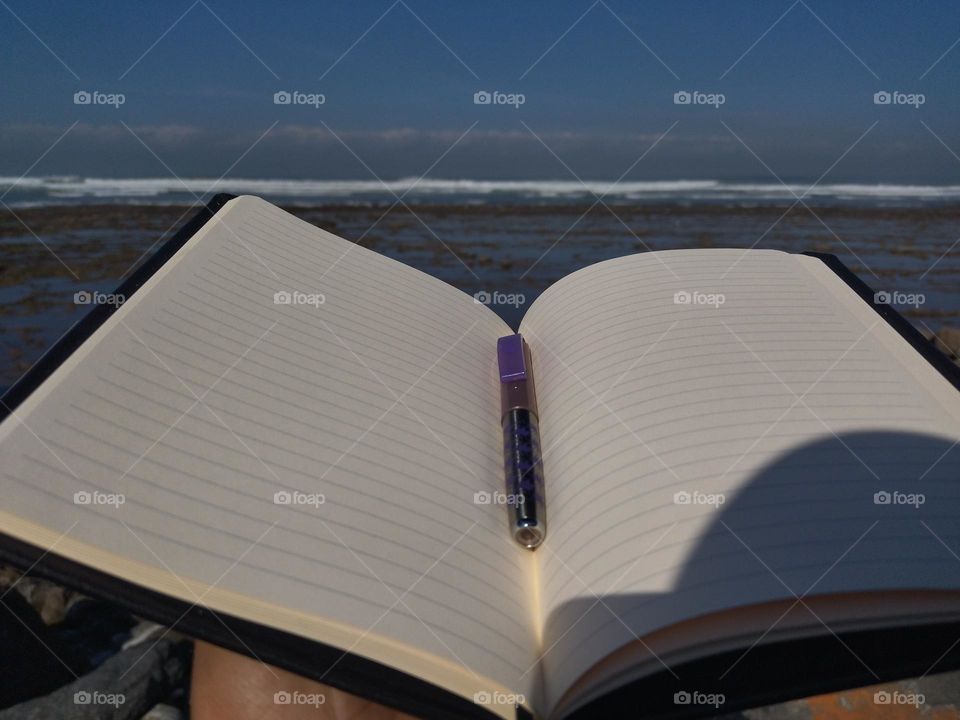 Notebook and pen and the beach