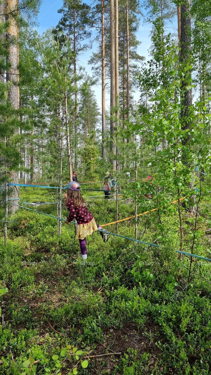 The children are playing and having adventures in the Finnish forest