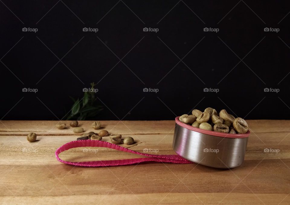 raw coffee beans on wooden table