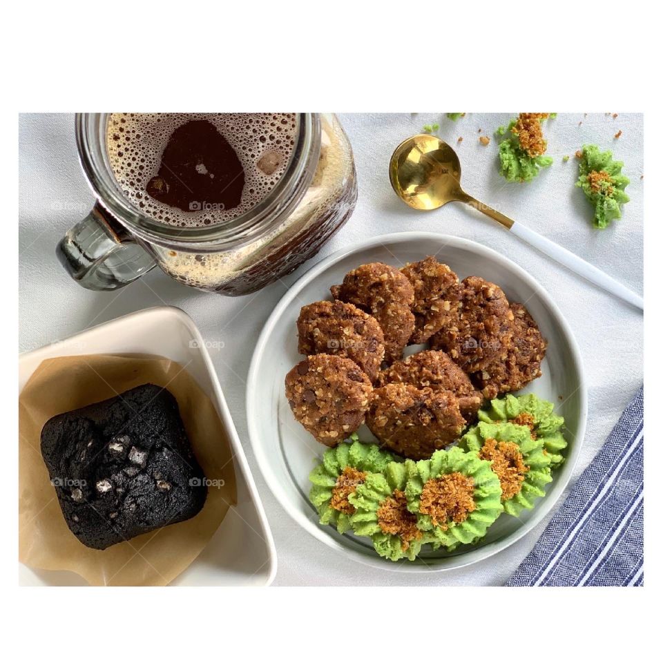 Afternoon snacks ondeh cookies and chocolate chip oat cookies with black brownie and sea salt and ice cold black coffee