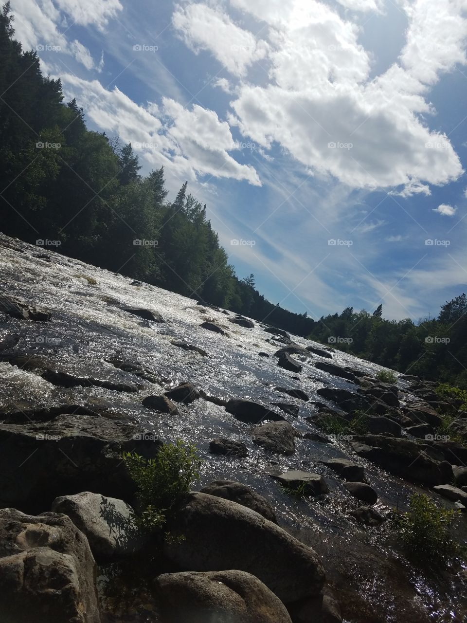 The sunny rapids flowing on a Summer day