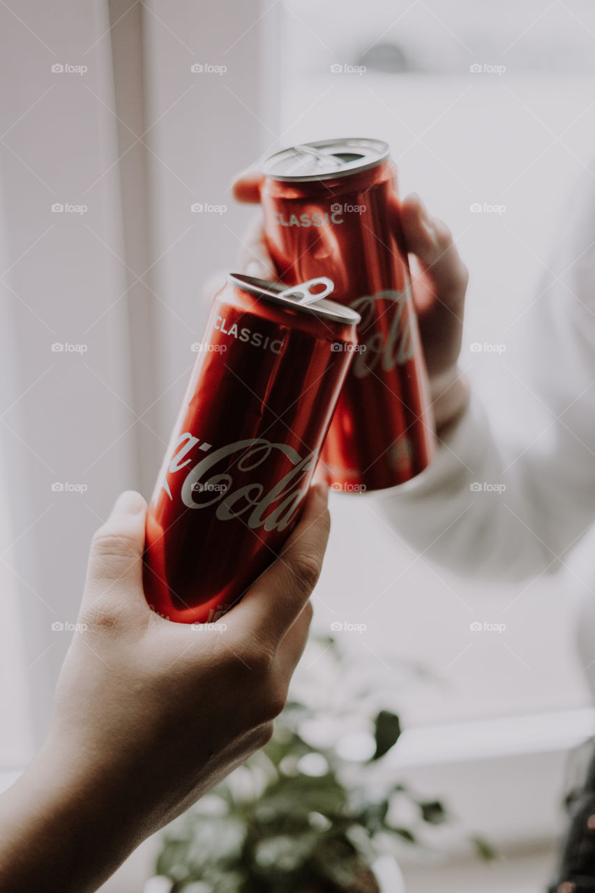 coca cola in hands / cheers with coca cola