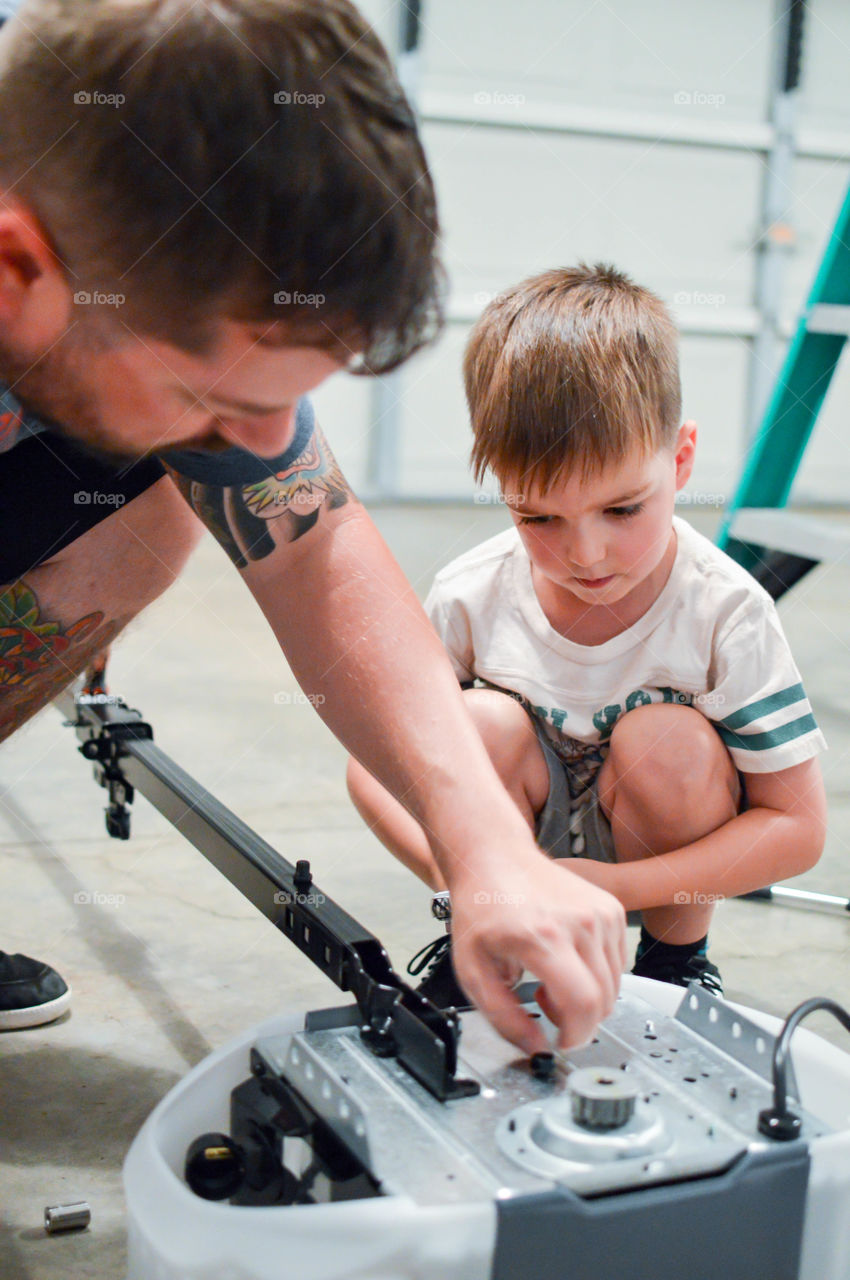 Father and son making repairs together