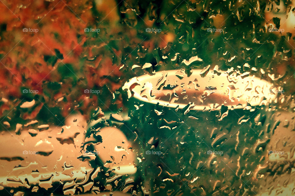 Coffee cup outside the window, rainy day