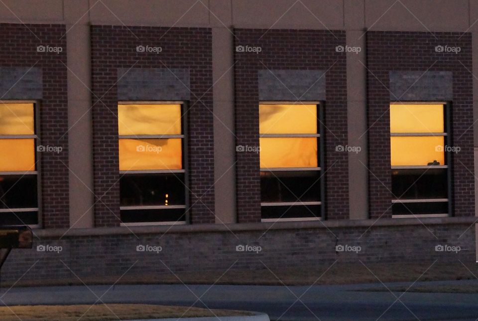 Golden sunset reflection. Row of windows