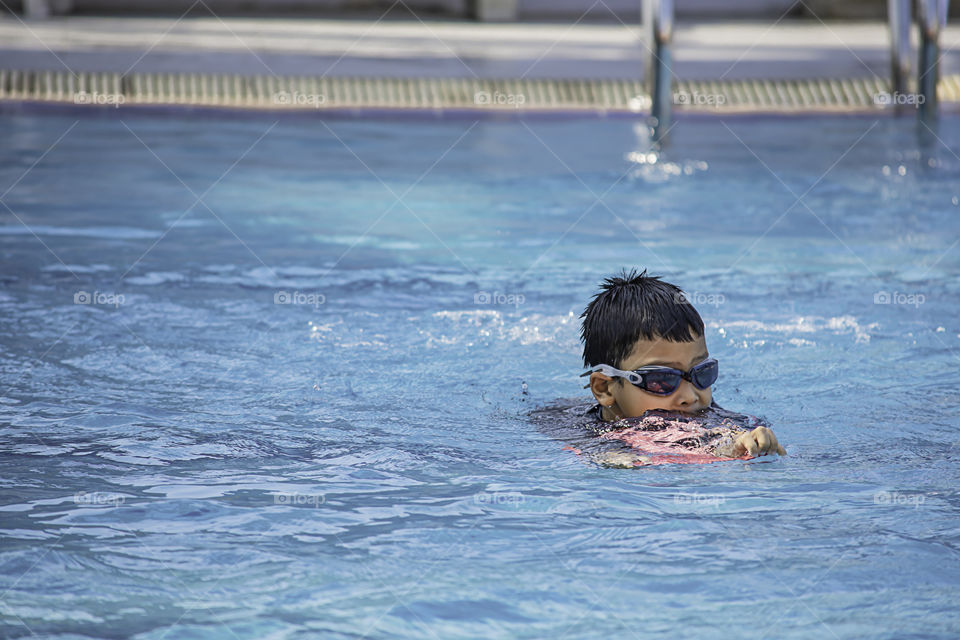 Asean boys are swimming in the pool.