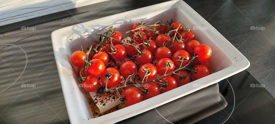 Feta cheese and cherry tomatoes ready for oven