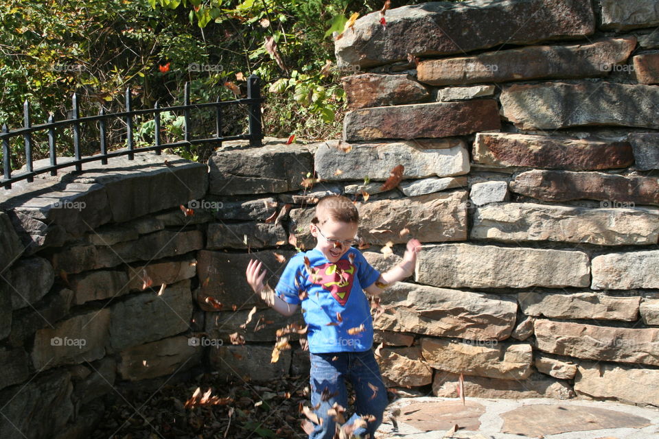 Boy playing with dry leaf