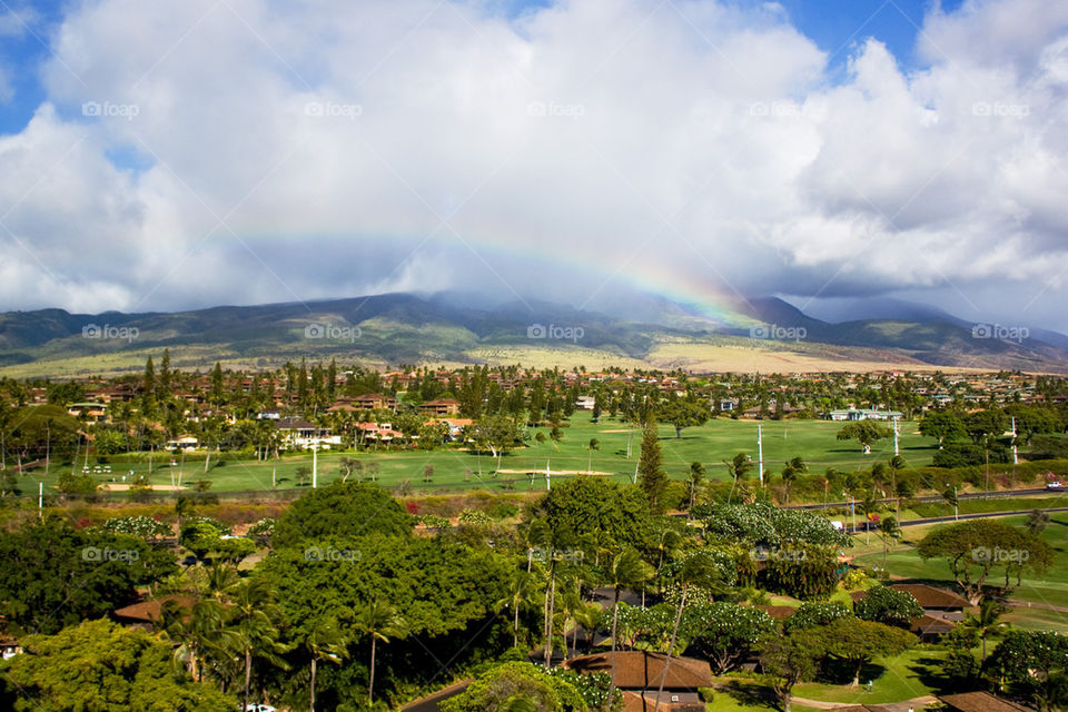 Scenic view of rainbow over town