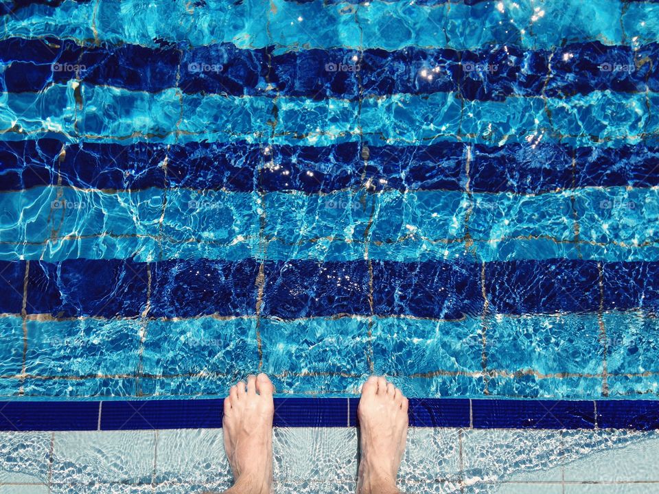 Man staying in the swimming pool 
