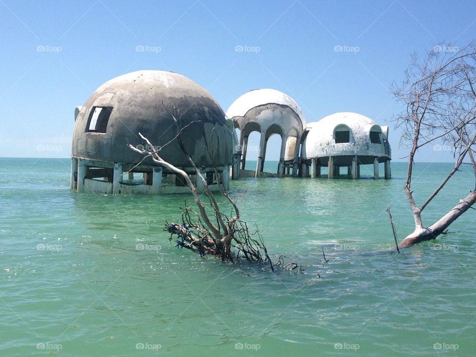 Sinking into the sea. Near Marco Island, Florida, a unique looking fine shaped home slowly floats into the sea. 