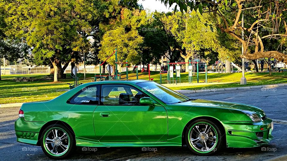 Bright green car in parking lot!
