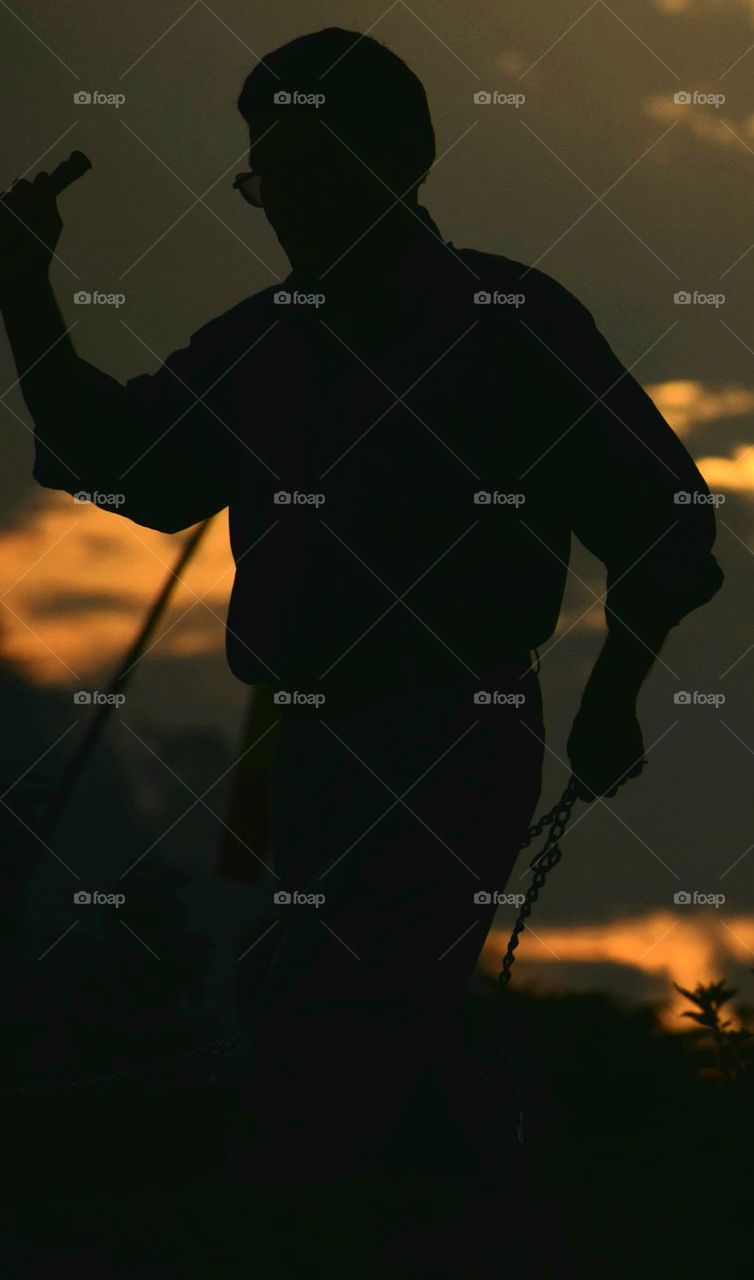 A silhouette
the image of a person or scene represented as a solid shape of a single colour usually black, with its edges matching the outline of the subject