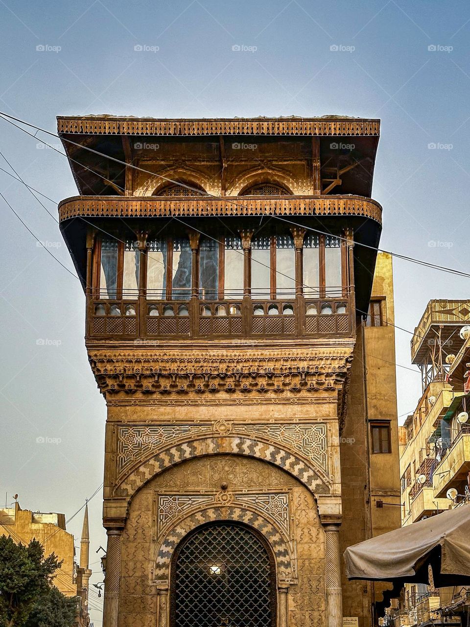 A beautifully carved wooden balcony in Historic Cairo, showcasing the intricate craftsmanship typical of the historic buildings in this culturally rich area.