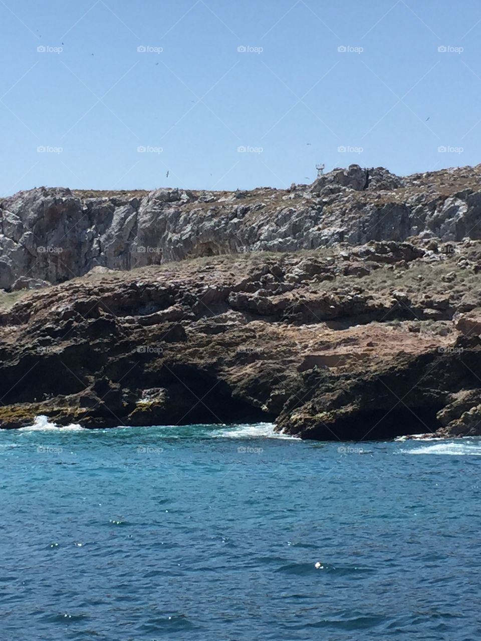 Rocky cliff side of an island off the coast of Puerto Vallarta 