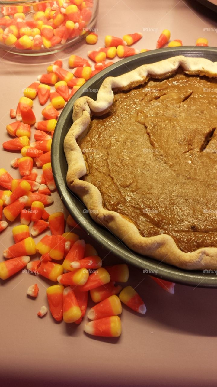 Pumpkin pie with candy corn. A pumpkin pie surrounded by candy corn.
