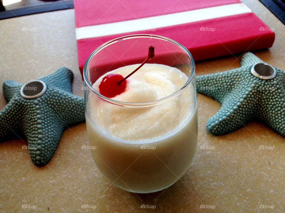 Glass of pina colada with cherry inside