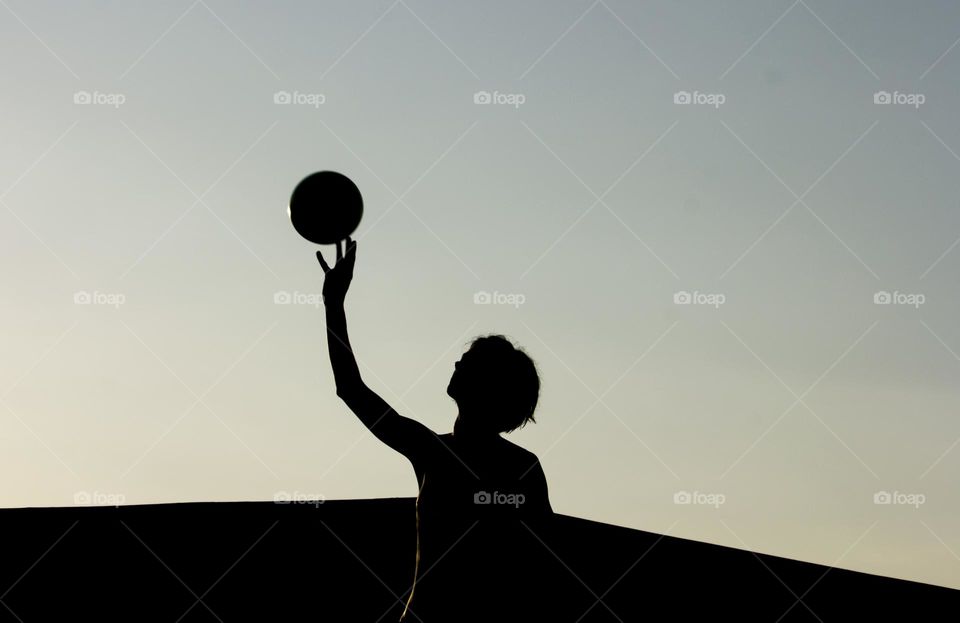 Silhouette of a woman and a ball outdoor