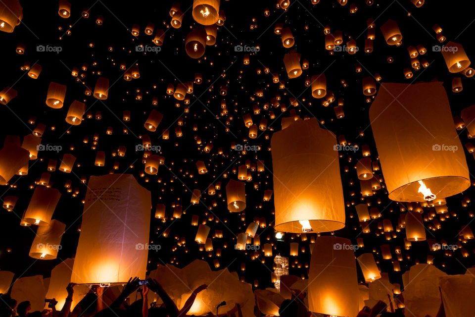 Crowd releasing lanterns into sky