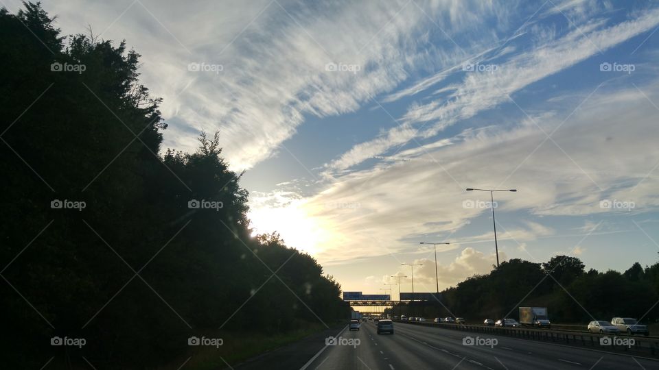 Highway in the city against cloudy sky