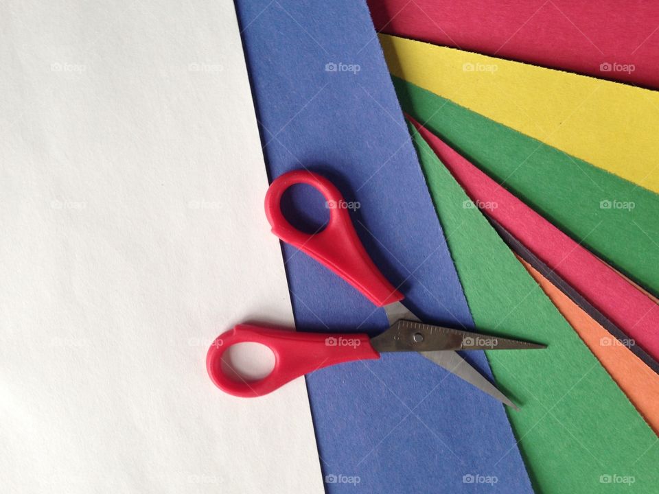 High angle view of scissor with colorful papers