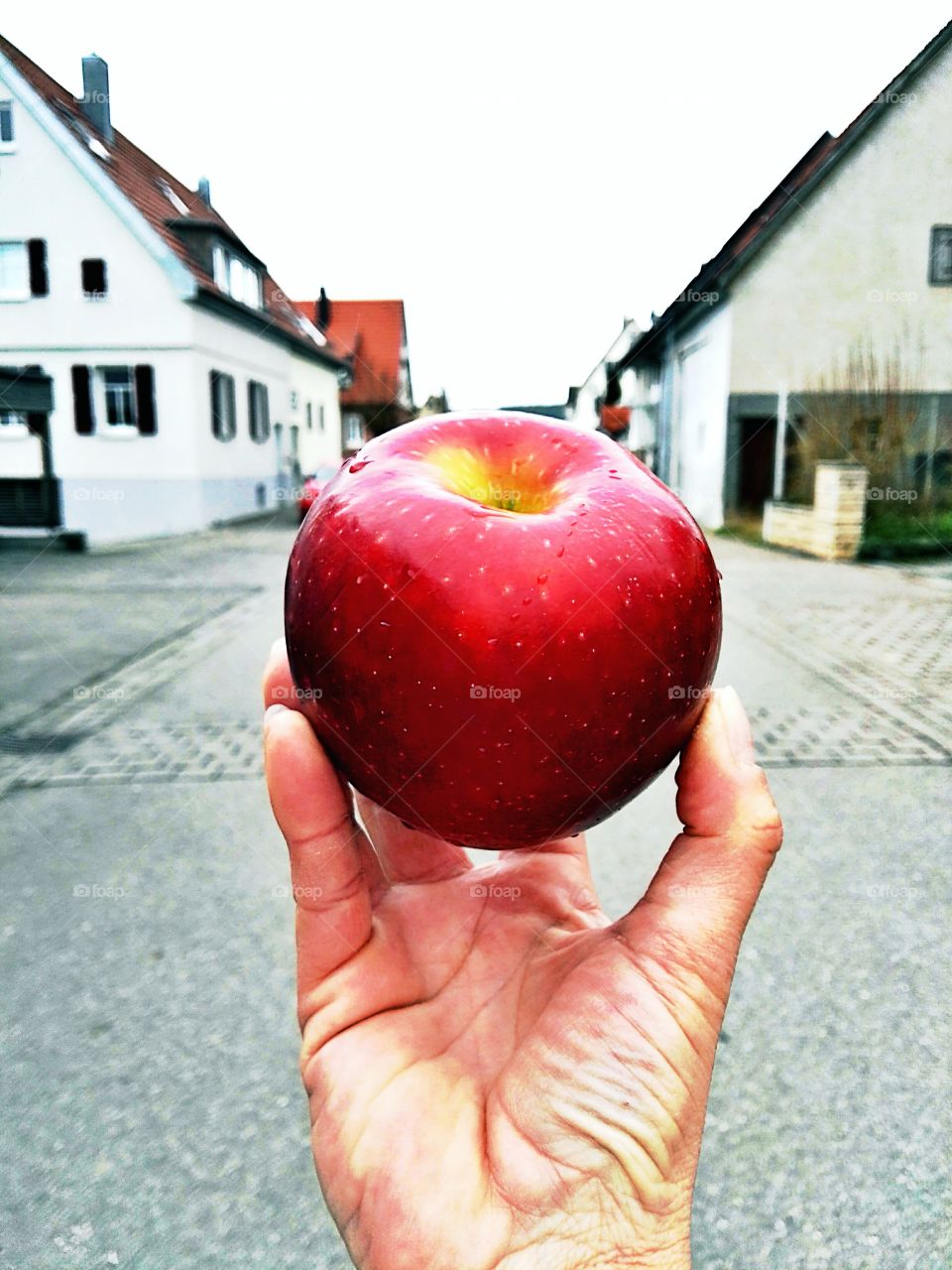 jucy fresh red apple on street background
