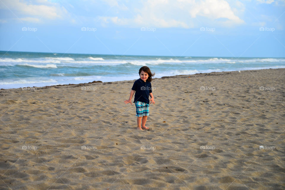 Girl standing on sandy beach