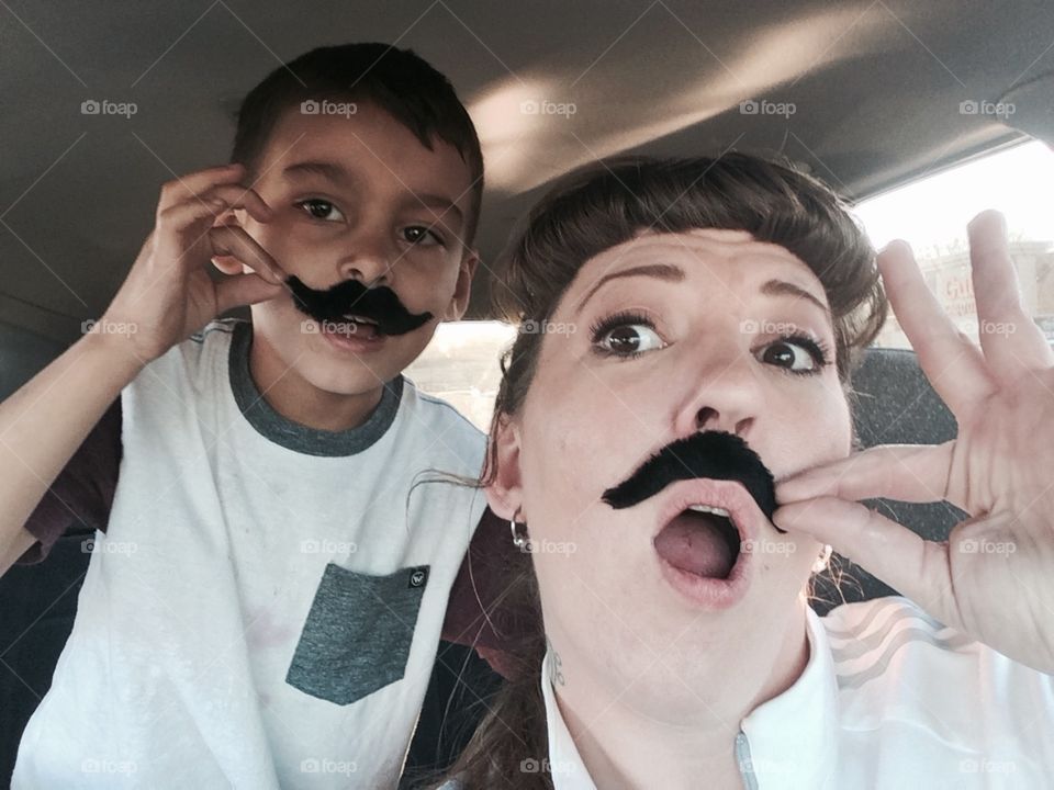 Playtime with fake mustaches in public is what makes this aunt the most fun to hang out with.